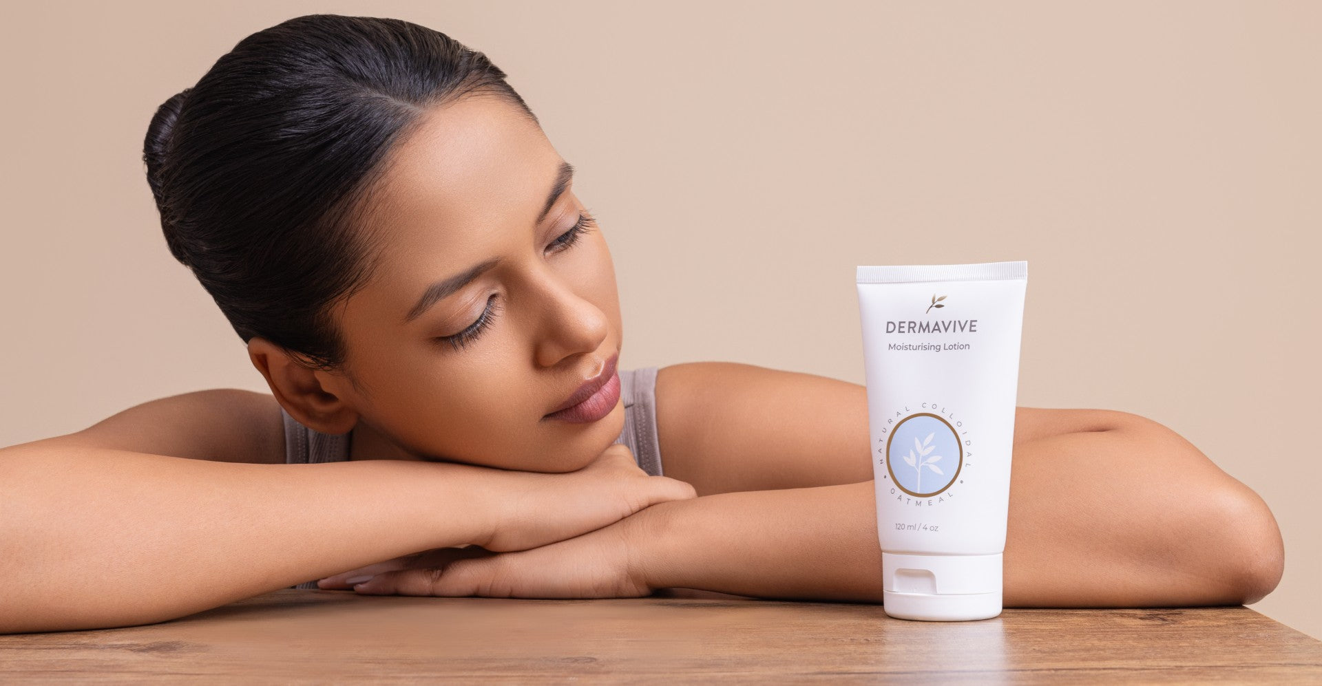 Model showcasing natural skincare best sellers with a moisturizing product in hand