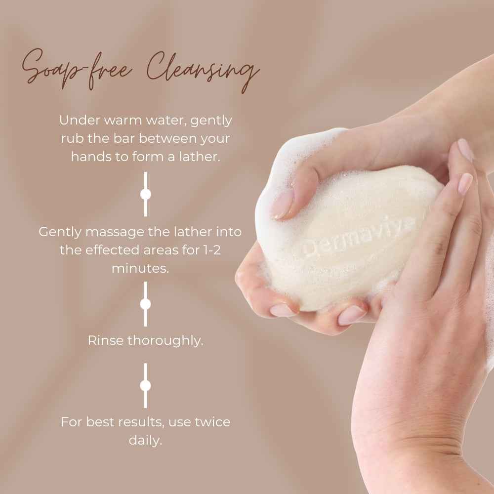 Dermavive sensitive skin cleansing bar held in hands with cleansing instructions on beige background